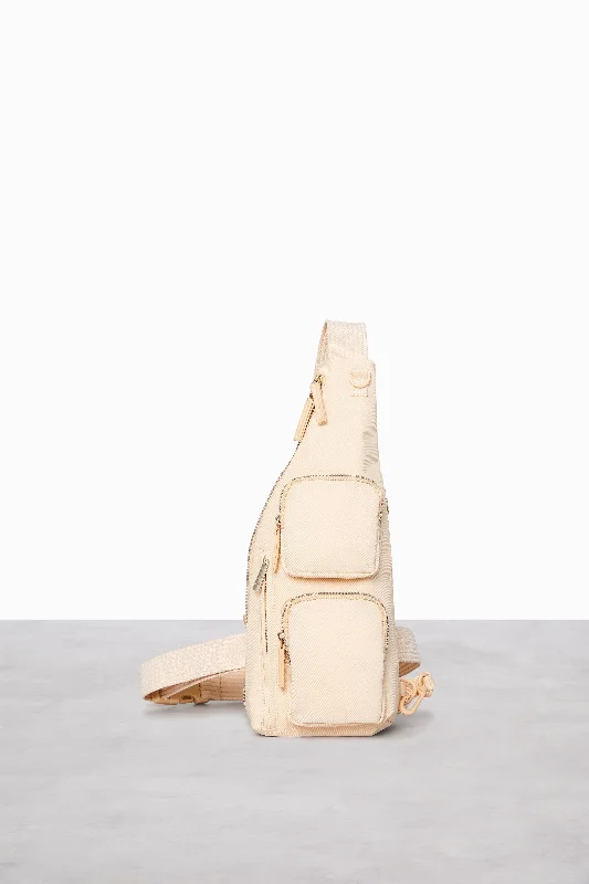 Soft - sided travel bag with reinforced corners for durabilityThe Survival Sling in Beige