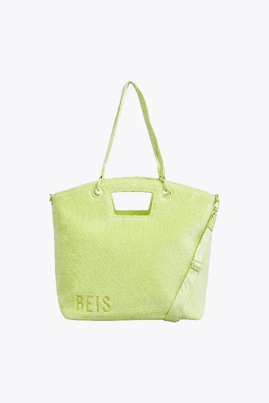 Compact carry - on travel bag with spinner wheels for easy maneuvering in airportsThe Terry Tote in Citron