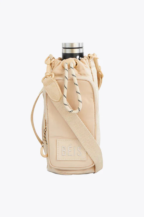 Travel bag with a detachable toiletry pouch for convenienceThe Water Bottle Sling in Beige