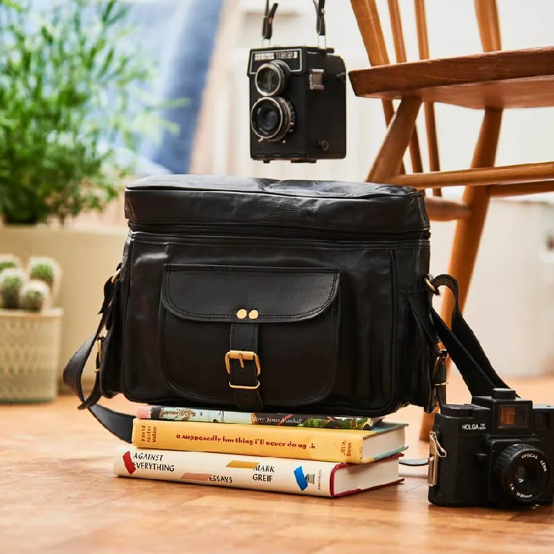 Smart travel bag with integrated GPS tracker for lost item recoveryBlack Leather Camera Bag